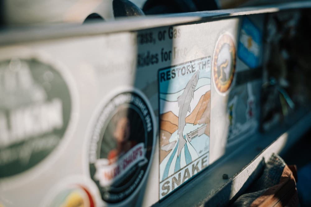 Conservation stickers on a drift boat, including Restore the Snake